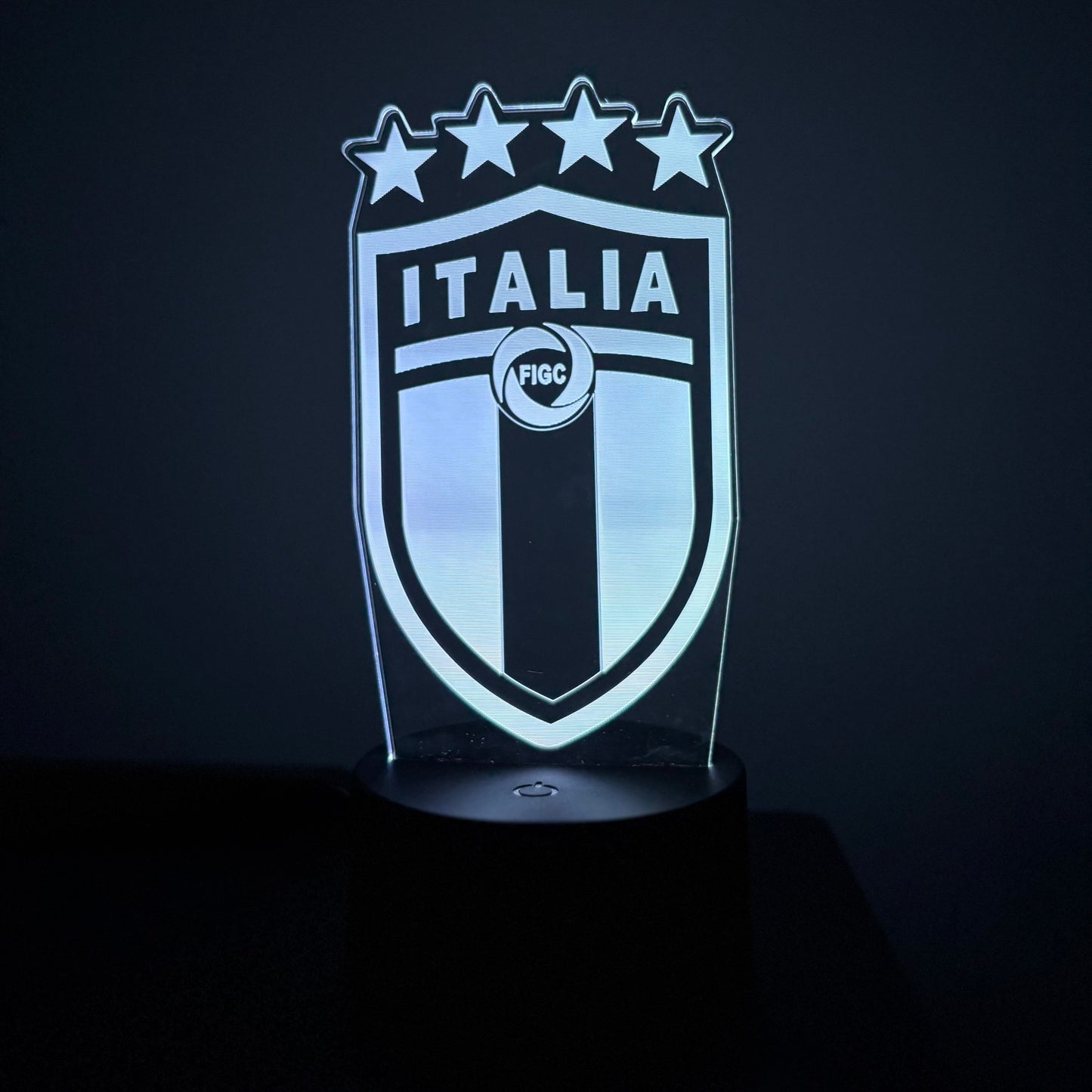 Light-up shield with 'Italia' text and star design on a dark background